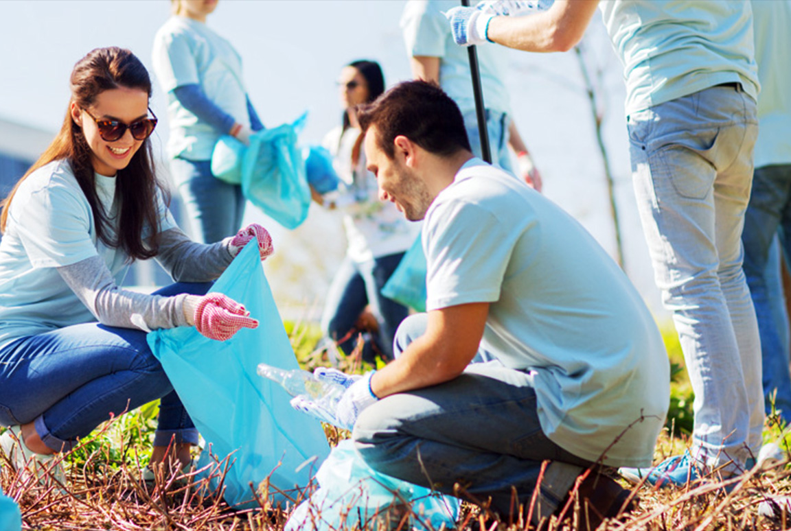 group of people planting flowers in an urban community garden